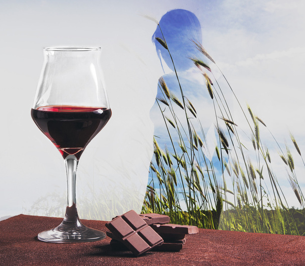Wine with chocolate and double exposed girl in wheat field - Foto, imagen