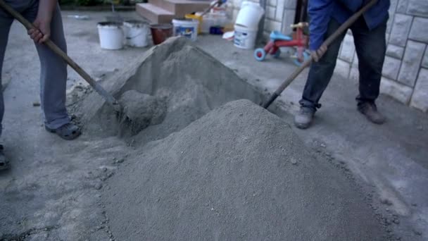 férfiak keverés mész és a homokot lapátol - Felvétel, videó