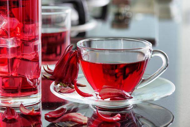 Cup of hibiscus tea (rosella, karkade) on kitchen table - Фото, зображення
