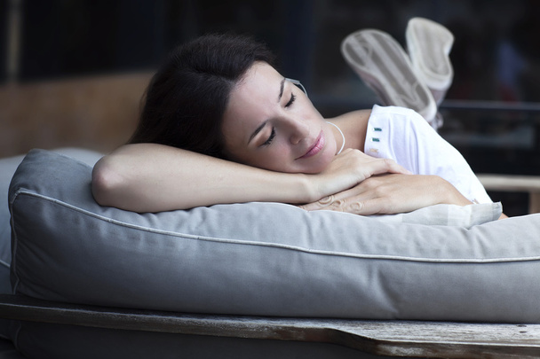 Happy adult latin woman sleeping outdoors - Photo, Image