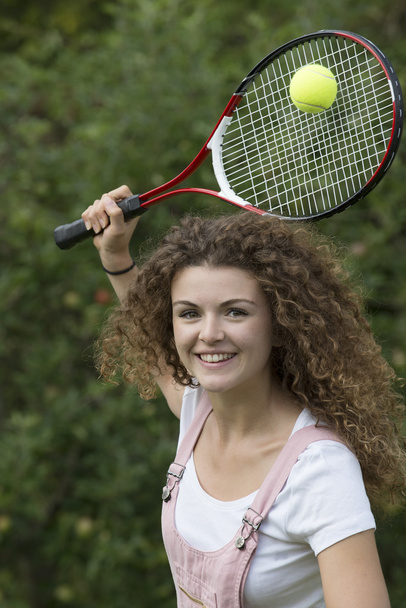 Attractive teenager playing tennis - Fotó, kép
