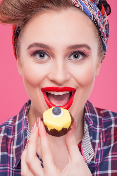 Cute young woman is eating sweet food - Fotó, kép