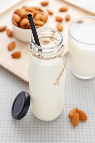 Almond milk bottle with straw - Foto, imagen