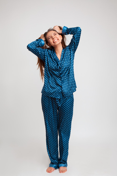 young beautiful girl in a blue pajamas - Fotoğraf, Görsel