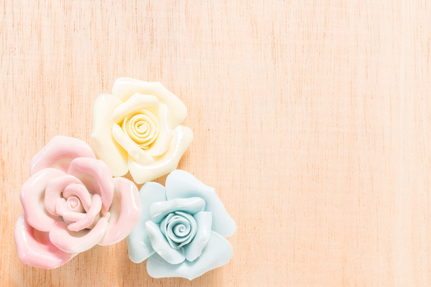 Closeup Pastel Rose (Ceramic ) on wooden background - Photo, Image