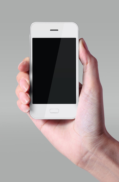 Λευκό smartphone με το χέρι που απομονώνονται σε γκρι φόντο. - Φωτογραφία, εικόνα