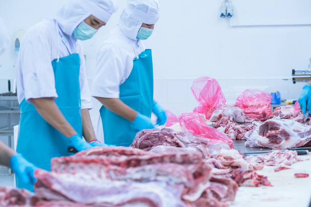 cutting meat slaughterhouse workers in the factory - Photo, Image