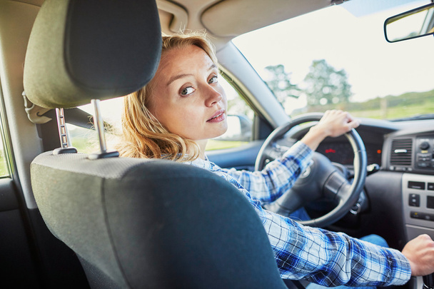 Young confident woman driving a car - Фото, зображення