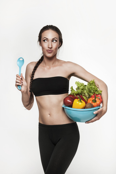 Retrato de jovem mulher apta a comer legumes
  - Foto, Imagem