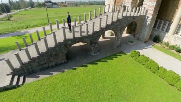 Man stands on a stairs of an old church - Footage, Video