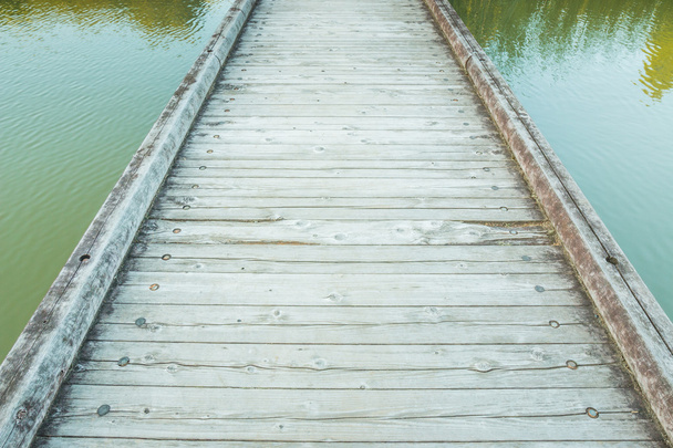 Wooden Bridge over a Pond in the Park - Foto, afbeelding