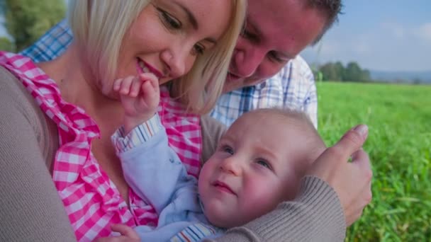 Eltern streicheln Baby im Arm - Filmmaterial, Video