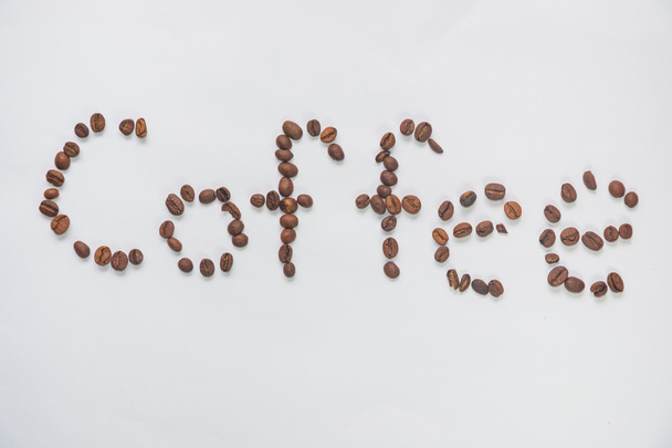 Inscription "coffee" from coffee grains on a white background - Foto, Imagem