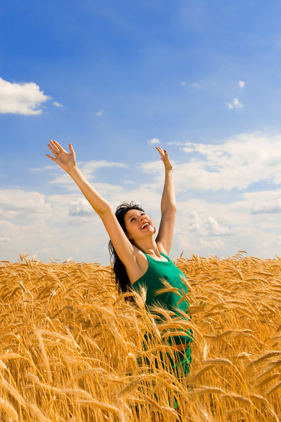Happy woman jumping in golden wheat - Foto, Imagem