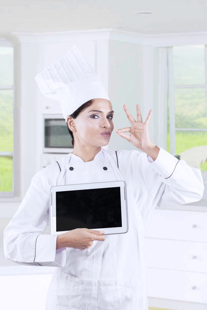 Attractive female chef with tablet in kitchen - Zdjęcie, obraz