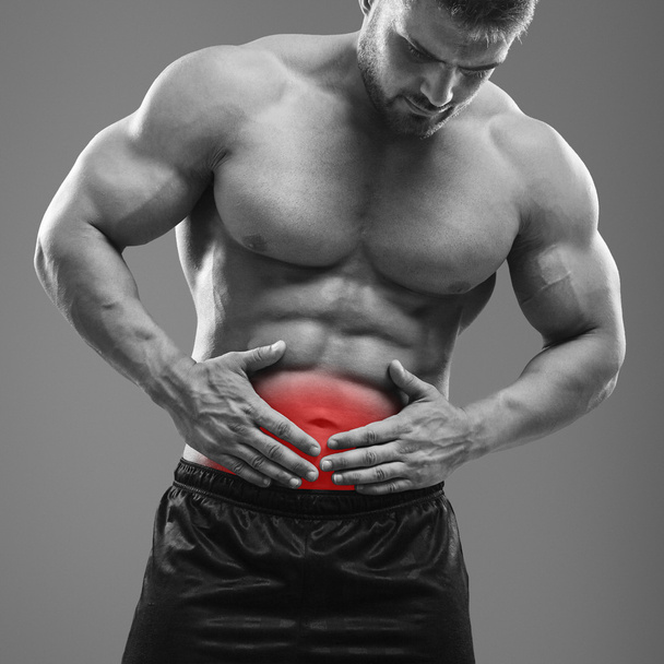 Muscular man stomach ache - Valokuva, kuva