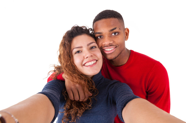 Happy mixed race couple taking a selfie photo over a white backg - Zdjęcie, obraz