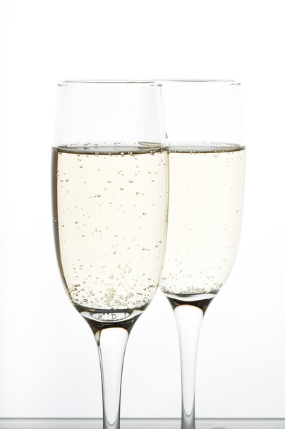 two glasses of champagne on white background - Foto, imagen