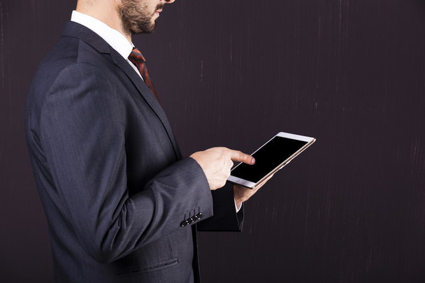 Businessman pointing to his digital tablet  - Фото, зображення