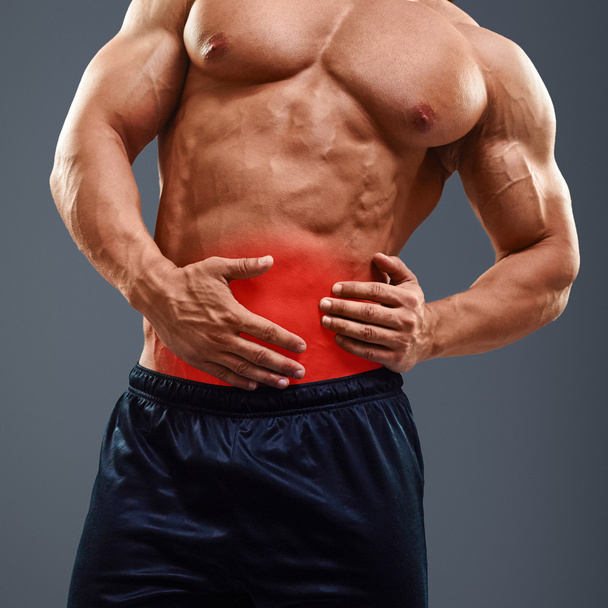 Ahtletic muscle man Pain in abdomen - Photo, Image