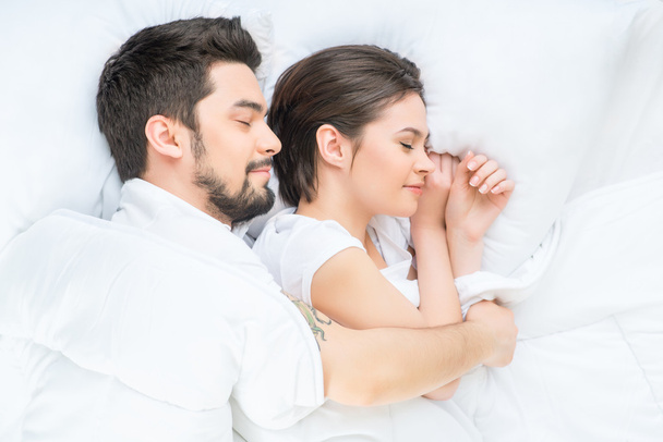 Nice loving couple lying in bed - Photo, Image