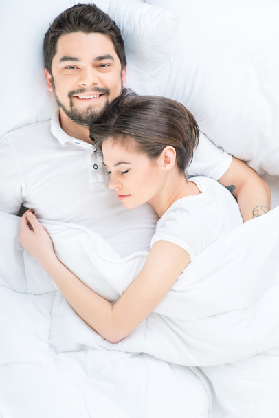 Nice loving couple lying in bed - Zdjęcie, obraz