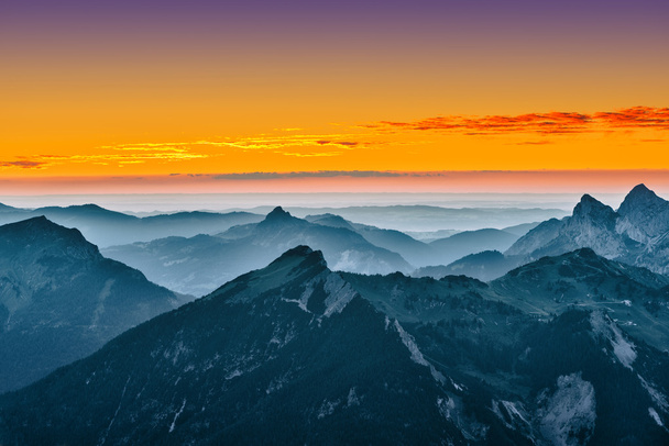 view over blue mountains with golden yellow sunset sky - Photo, Image