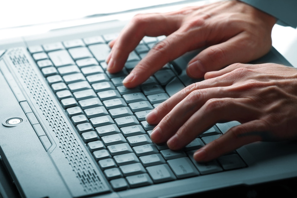 Male hands typing on a laptop - Photo, Image