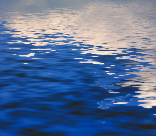 Beauty Surface Rippled of water with reflection clouds and sky background - Photo, Image