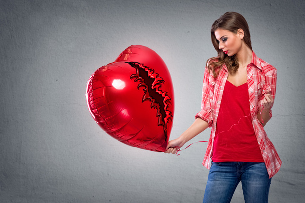 Woman holding a heart shaped balloon - Foto, Bild