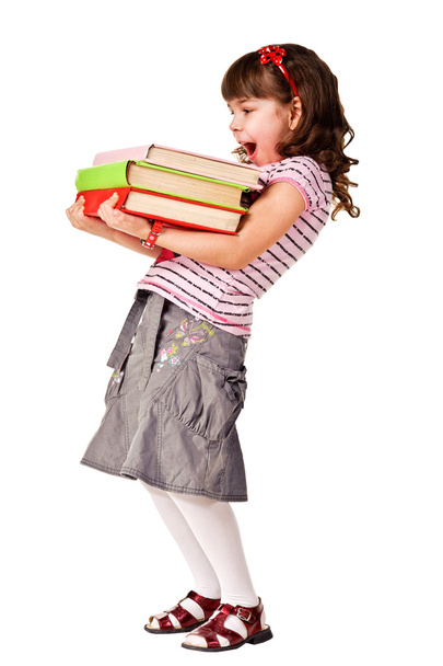 Happy little schoolgirl with a stack of heavy books - Foto, Imagem