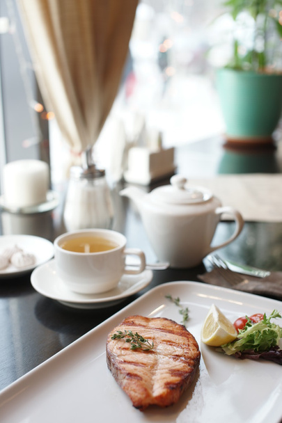 Grilled salmon and tea on the table - Photo, Image