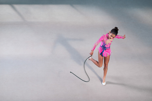 gymnast in a beautiful dress dancing with  rope - 写真・画像