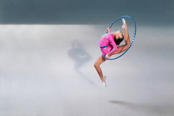 gymnast  beautiful  dress with a hoop in  jump - Fotó, kép