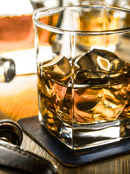 Whiskey on the rocks on a wooden table - Foto, imagen