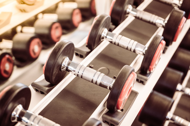 Dumbbell equipment in fitness gym - Фото, изображение