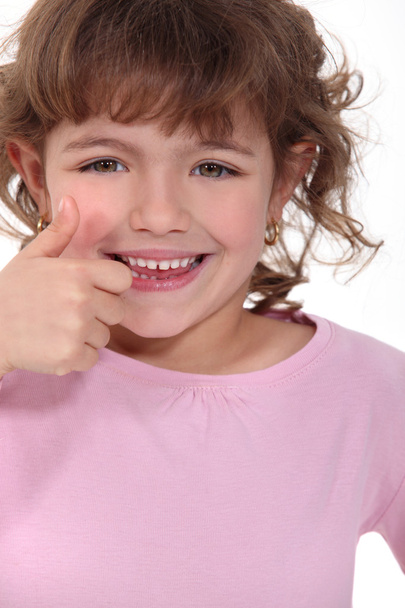 Little girl giving thumbs-up - 写真・画像