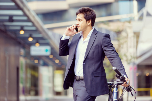 Successful businessman riding bicycle - Foto, Imagen