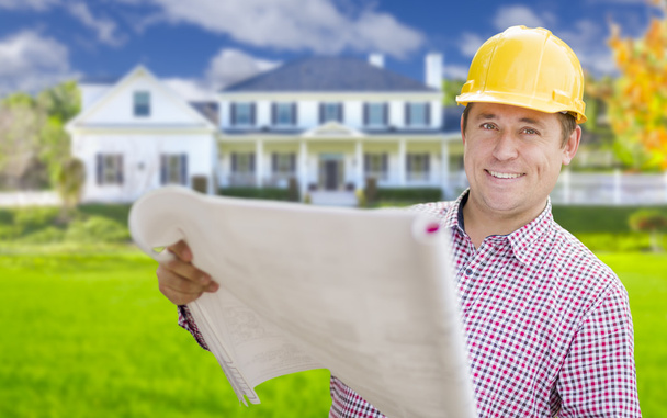Contractor Holding Blueprints In Front of  Beautiful Custom Home - Foto, immagini