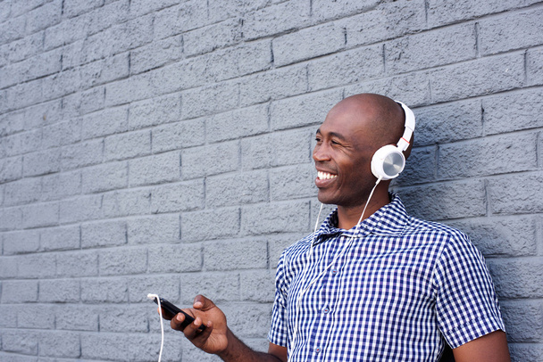 Smiling black guy with mobile phone - Photo, Image