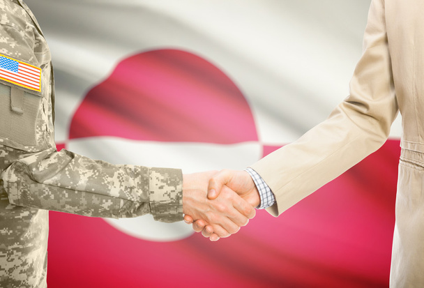 USA military man in uniform and civil man in suit shaking hands with national flag on background - Greenland - Fotografie, Obrázek