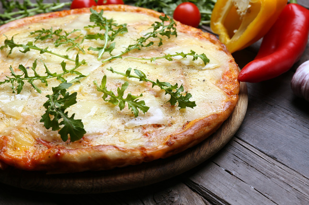 Tasty pizza decorated with herbs and vegetables on wooden background, close up - Fotoğraf, Görsel