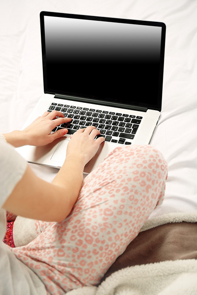 Woman in pajamas using laptop  - Fotoğraf, Görsel