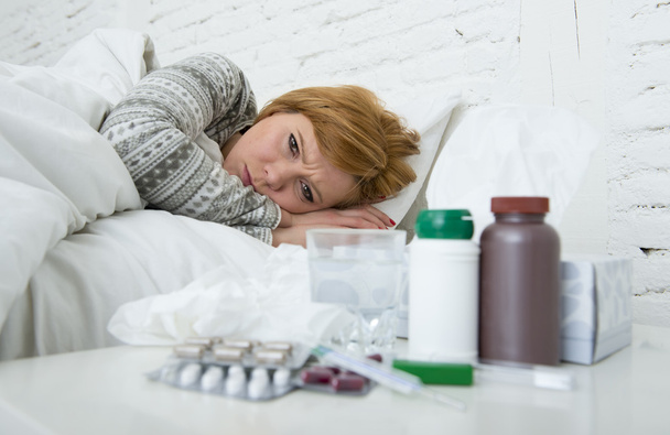  sick woman feeling bad ill lying on bed suffering headache winter cold and flu virus having medicines - Фото, зображення