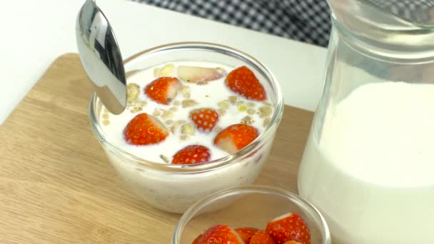Breakfast, pick up spoon, scoop cereal with strawberries, ready to eat, slow - Materiaali, video