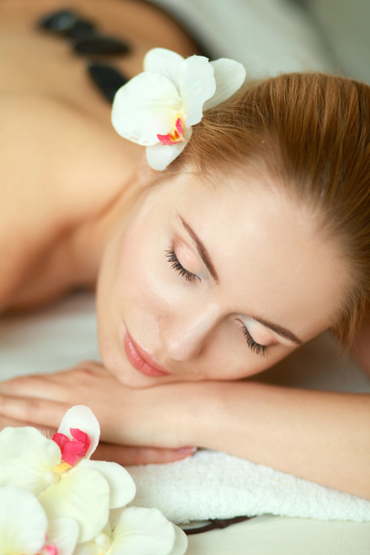 Beautiful young woman getting spa massage, lying on salon - Фото, зображення
