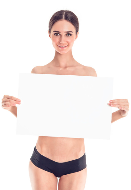 Sexy naked girl with a poster. Clean skin. Hair removed. Isolate. For advertising and presentation. - Foto, Imagen