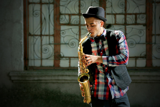 Young man with saxophone    - Photo, Image