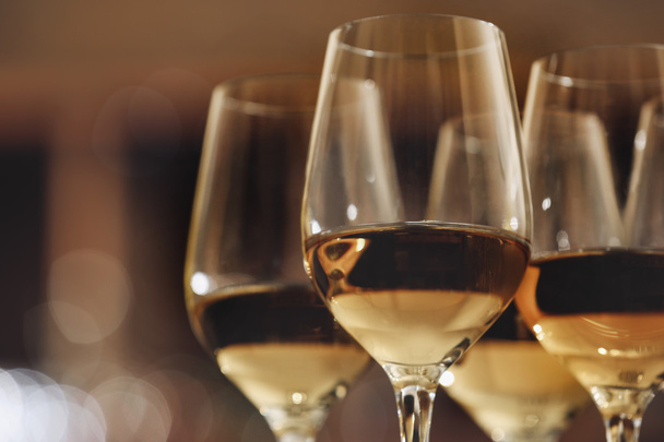 Glasses with white wine on blurred background - Fotó, kép