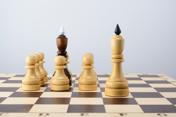 Black king surrounded by white pawns - Photo, Image